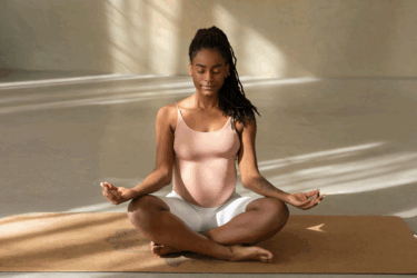 pregnant woman practicing meditation and self-care