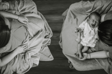 anxiety; woman sitting across from delivered baby