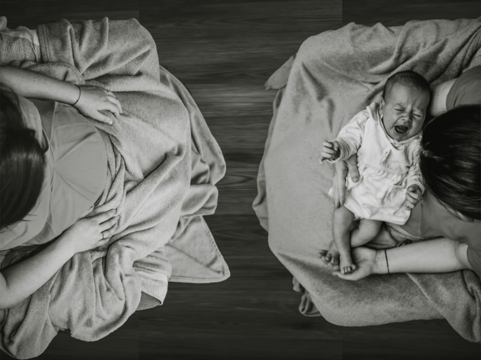 anxiety; woman sitting across from delivered baby