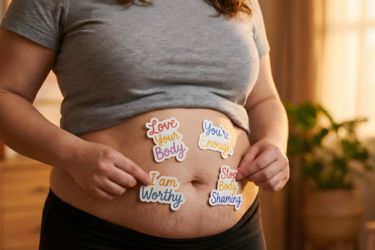 postpartum body; woman with affirmations on belly